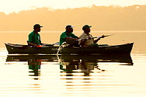 Park rangers in boat,  Lagoons of Cufada ( Lagoas de Cufada)  Natural Park, Guinea Bissau. February 2015