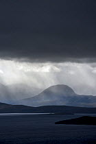 Stormy sky and downpour during rain storm over desolate wilderness of Coigach, Wester Ross in the Northwest Highlands of Scotland, UK, September 2016.