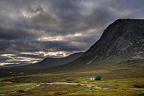 The remote Lagangarbh Hut along River Coupall in front of Buachaille Etive Mor in Glen Coe on a rainy day, Scottish Highlands, Scotland, UK, September 2016