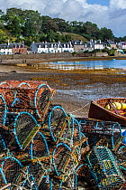 Stacked lobster creels / traps on quay in the Plockton Harbour, Scottish Highlands, Scotland, UK, September 2016