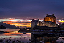 Illuminated Eilean Donan Castle at sunset in Loch Duich, Ross and Cromarty, Western Highlands of Scotland, UK, September, 2016