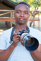 Pupil Israel Morei with DSLR camera during residential photography course organised by Wild Shots Outreach. Kruger National Park, South Africa, June 2017.