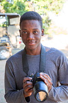 Pupil Chris Mojela with DSLR camera during residential photography course organised by Wild Shots Outreach. Kruger National Park, South Africa, June 2017.
