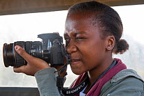 Pupil Evelyn Lekanyane with camera during residential photography course organised by Wild Shots Outreach. Kruger National Park, South Africa, June 2017.
