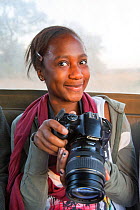 Pupil Evelyn Lekanyane with camera during residential photography course organised by Wild Shots Outreach. Kruger National Park, South Africa, June 2017,