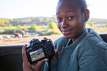 Pupil Prisence Mashaba showing the photo she has just taken on the back of her camera, during residential photography course organised by Wild Shots Outreach. Kruger National Park, South Africa, June.