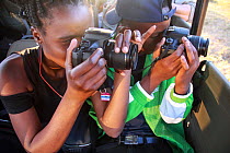 Students taking pictures during residential photography course organised by Wild Shots Outreach. Kruger National Park, South Africa, June.
