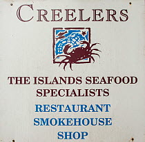 Sign for 'The islands seafood specialists' restaurant, smokehouse and shop, Isle of Arran, with produce from South Arran Marine Protected Area, Scotland, UK, August 2016.