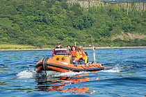 Five people aboard tourist boat in waters south of the Isle of Arran, Lamlash Bay, Isle of Arran, South Arran Marine Protected Area, Scotland, UK, August.