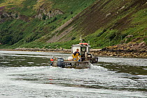Fisherman deploying lobster pots from boat, Lamlash Bay, Isle of Arran, South Arran Marine Protected Area, Scotland, UK, August 2016.