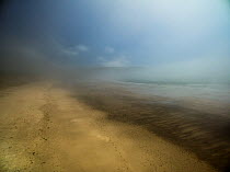 Beach with mist during warm spell, Hells Mouth, Porth Neigwl, Abersoch, Gwynedd, Wales, UK, July 2016.