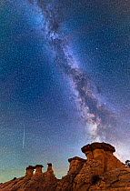 Hoodoo cap sandstone rock formations with milky way above and meteor shower, Escalante canyon walls, Grand Staircase- Escalante National Monument , Utah, USA, October.