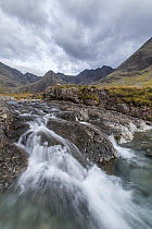 Waterfall on upland stream with Bruach na Frithe and Cuillins in background, Fairy Pools, Glen Brittle, Isle of Skye, Scotland, UK, October 2016.
