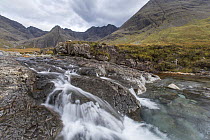 Waterfall on upland stream with Bruach na Frithe and Cuillins in background, Fairy Pools, Glen Brittle, Isle of Skye, Scotland, UK, October 2016.