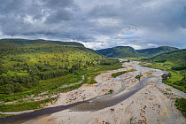 Aerial view of braided channel of River feshie, with regenerating Scots pine (Pinus sylvestris) forest and Carn Dearg Mor in background, Glenfeshie, Cairngorms National Park, Scotland, UK, June 2016.
