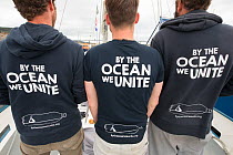 Three research crew members on yacht operated by By The Ocean We Unite Foundation, a Dutch charity exploring microplastics in the North Sea, Inverness, Scotland, UK, June 2017