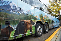 Touring bus showing wildlife branding on side, Jasper National Park, Alberta, Canada, June