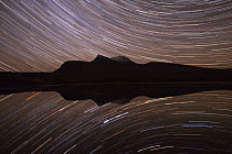 Star trails over Cul Mor reflected in water, Assynt, Sutherland, Scotland