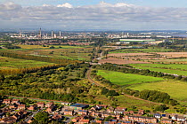 View from Helsby Hill showing the industrial areas of Stanlow and Elton with the main railway line and the M56 and the houses of Helsby in the foreground Cheshire, UK, September.