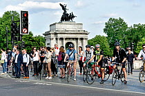 Commuter cyclists and pedestrians waiting to cross road, Hyde Park Corner, Central London, England, Britain, UK, June 2015.