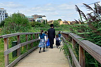 Jewish family walking along broadwalk, Woodberry Wetlands, formally Stoke Newington East Reservoirs. The reserve is managed by the London WildlifeTrust Trust and owned by Thames Water, London Borough...