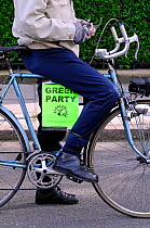 Green Party poster on bike ridden by activist, General Election 2015, Highbury, Islington North Constituency, London England Britain UK, May 2015.