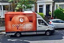 Ocado van with driver delivering to a street in Holloway, London Borough of Islington, England UK, August 2016.