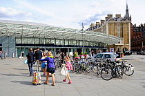 Passengers walking towards Kings Cross train station, London, England, Britain, UK, August 2014.