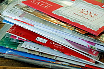 Pile of unopened envelopes containing clothing catalogues and showing recycle logo London, UK, January 2015.