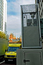 Pollution Monitor Euston Road with approaching ambulance and St. Pancras is background. Euston road is the 11th most polluted road in the UK. London, UK, November 2014.