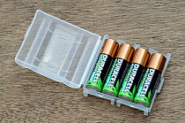 Four rechargeable batteries stored in plastic container.