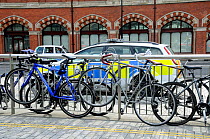 Bikes attached to railings showing the need for more bicycle racks in the vacinity of the station, Kings Cross, London, England, UK, August 2014.