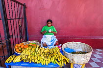 Woman selling bananas at fruit stall, Granada colonial town, Nicaragua.
