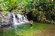 Woman bathing in pool of Rio Claro river. Corcovado National Park UNESCO World Heritage Site, Osa peninsula, Costa Rica