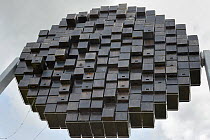 Reverse side of Swift tower with nest boxes for up to 100 pairs of Common swifts (Apus apus) designed as a public art work to look like a setting sun on the front side, Logan's Meadow Local Nature Res...