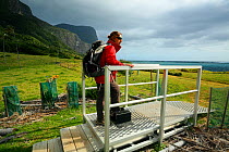 Hiker Eullia Vicens disinfecting her boots before entering Little Island trail, Lord Howe island, Lord Howe Island Group UNESCO Natural World Heritage Site, New South Wales, Australia, October 2012....