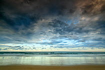 Clouds over the sea at dusk,  Seventy Five Mile beach at low tide, Fraser Island UNESCO World Heritage Site. Queensland, Australia, November.