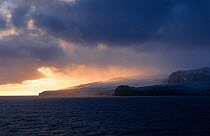 Sun through storm clouds over Heard Island, Heard and McDonald Islands UNESCO World Natural Heritage Site Sub-Antarctica.