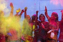 Children throwing coloured powder during Holi festival,  Jodhpur, Rajasthan, India. March 2015