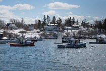 Lobster boats fishing through the winter, Bailey Island, Maine, USA, March 2017.