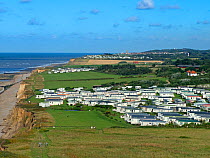 Static caravans near Beeston hill with Cromer in the distance, North Norfolk, England, UK, July 2017.