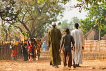 Ouled Rachid tibeswomen carrying buckets of water on their heads, village of Bon. Zakouma National Park, Chad, 2010.