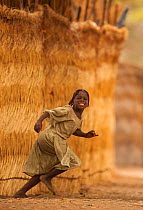 Ouled Rachid girl running, Bon Village, Zakouma National Park, Chad, 2010.