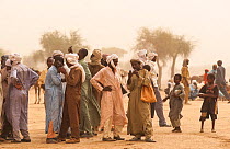 Ouled Rachid tribesmen in market, using mobile phones. Kashkasha village near Zakouma National Park, Chad, 2010.
