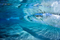 Surf crashing over sandy sea floor off the island of Maui, Hawaii.