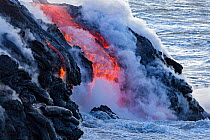 Pahoehoe lava flowing from Kilauea entering the Pacific ocean near Kalapana, Big Island, Hawaii. February 2011.