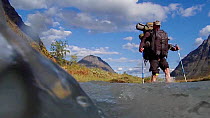 Photographer Erlend Haarberg, crossing the Rapa river in the Rapadalen valley. Sarek National Park, Laponia UNESCO World Heritage Site Swedish Lapland, Sweden. July 2014.