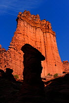 Shadow of hoodoo on sandstone cliff, Fisher Towers Recreation Site, Moab, Utah, USA. March 2014.