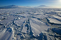 Sea ice, with Mount Terror (left) and Mount Erebus,  Ross Island, Ross Sea, Antarctica. Photographed for The Freshwater Project