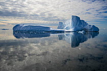 Iceberg reflected in still water of the Crystal Sound, near Detaille Island, Antarctic Peninsula, Antarctica  January 2017. Photographed for The Freshwater Project
